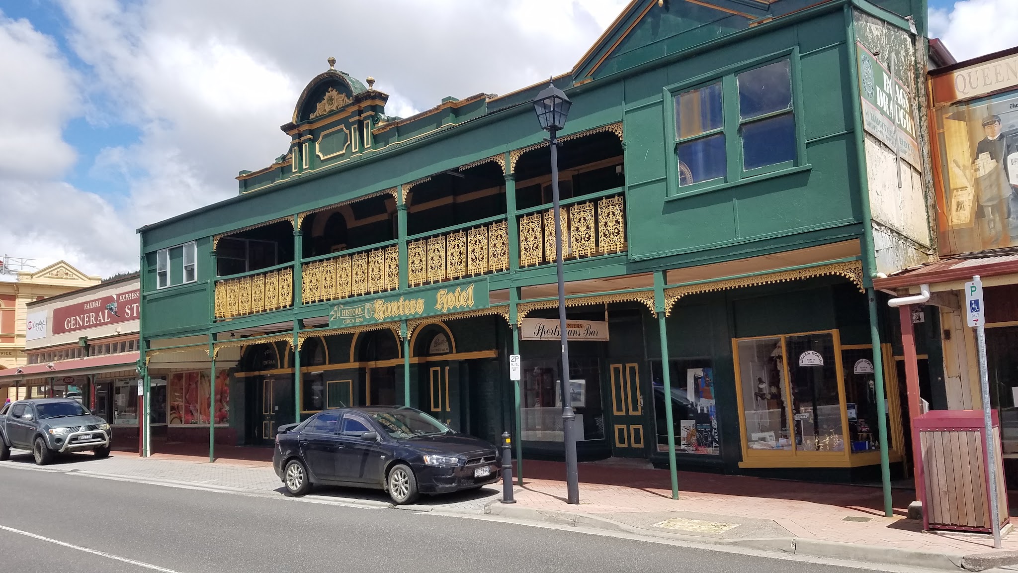 The green and gold frontage of Hunters Hotel seen from across Orr Street